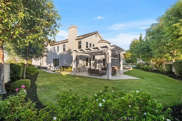 back of property with a patio, a yard, and a pergola