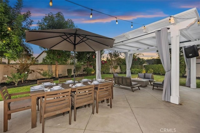 patio terrace at dusk with an outdoor living space and a pergola