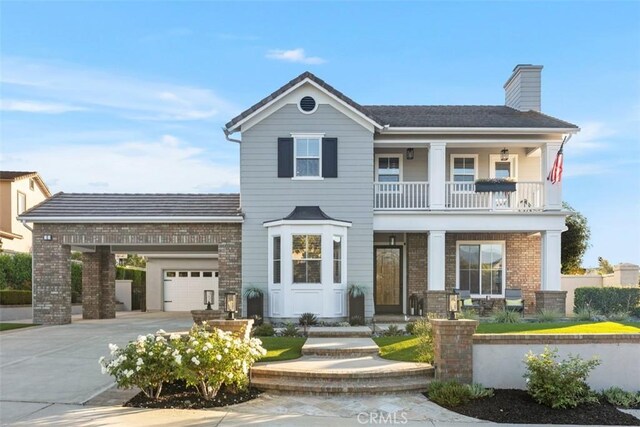 view of front of home with a garage and a balcony