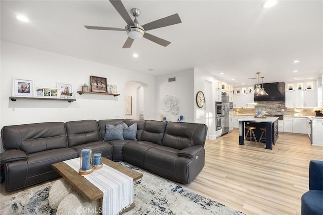 living room featuring ceiling fan and light wood-type flooring