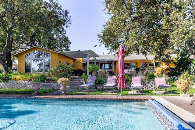 rear view of property with a patio and a pergola