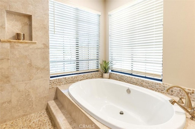 bathroom with tiled tub