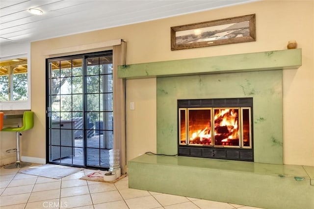 doorway featuring light tile patterned floors and a fireplace