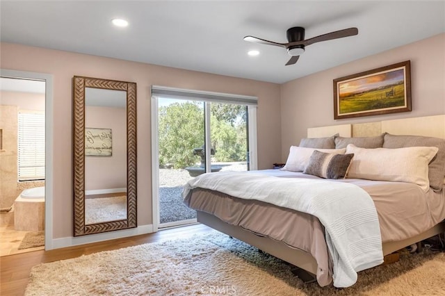 bedroom with light wood-type flooring, ceiling fan, access to exterior, and ensuite bath