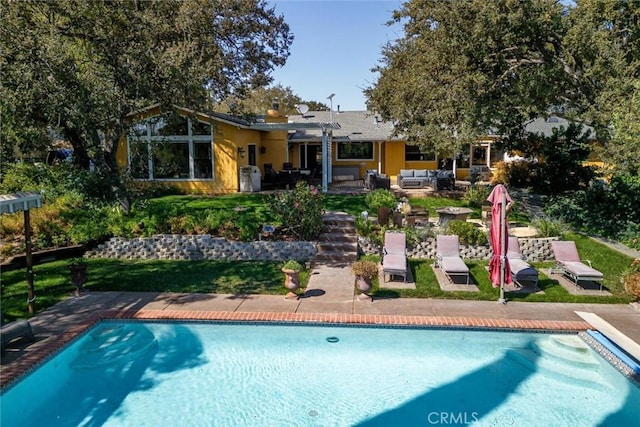 rear view of property with outdoor lounge area and a patio