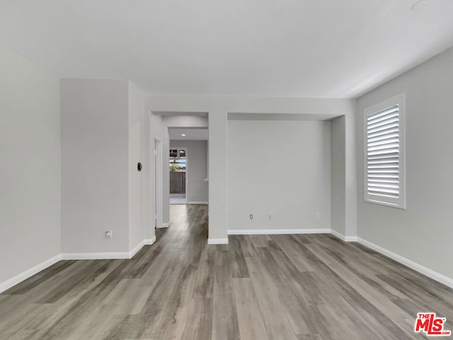 unfurnished room with wood-type flooring