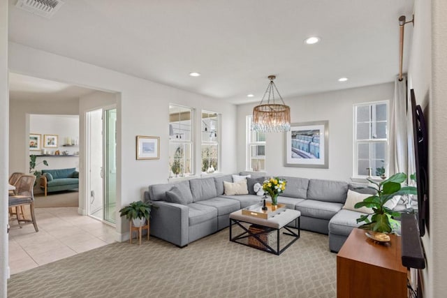 living room with a notable chandelier and light tile patterned floors