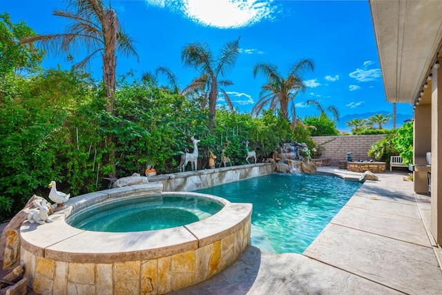 view of pool with an in ground hot tub and pool water feature