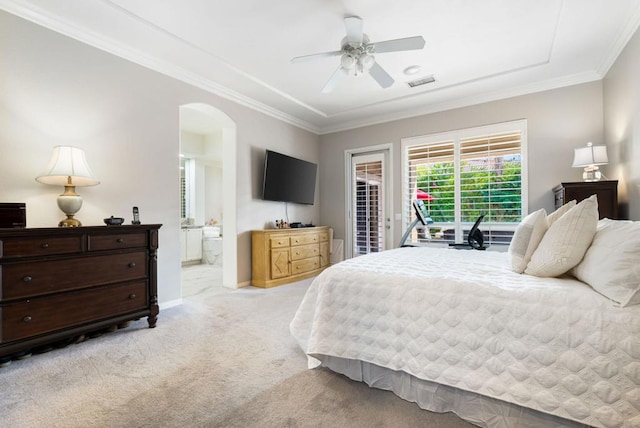 carpeted bedroom with crown molding, ensuite bathroom, ceiling fan, and access to outside