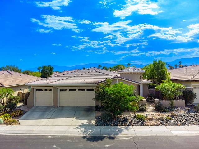 view of front of home featuring a garage and a mountain view