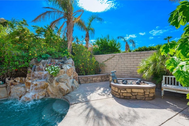 view of patio / terrace featuring an outdoor fire pit