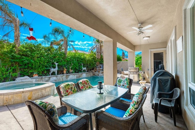 view of patio / terrace with an in ground hot tub, ceiling fan, and grilling area