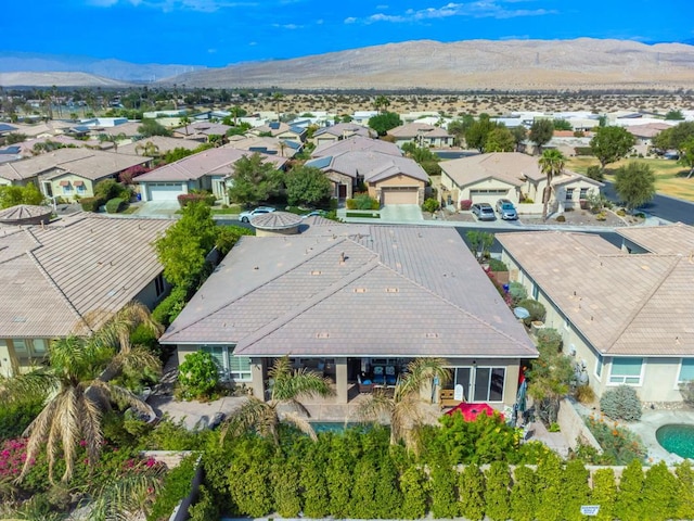 birds eye view of property with a mountain view