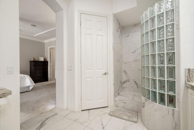 bathroom with crown molding and a shower