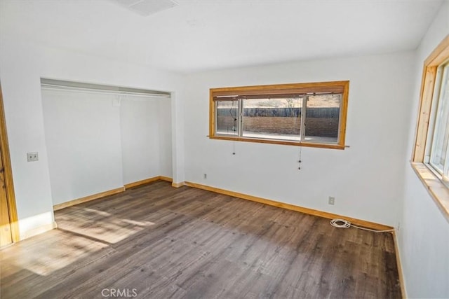 unfurnished bedroom with a closet and hardwood / wood-style flooring