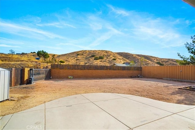 view of yard featuring a mountain view and a patio