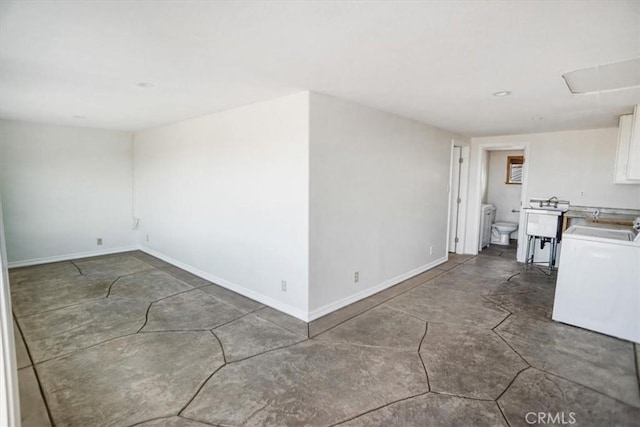 spare room with sink and washer / dryer