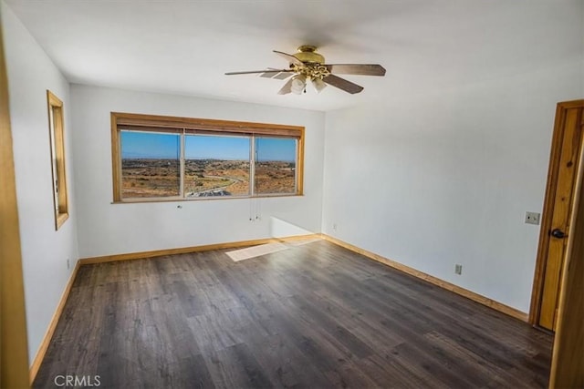 spare room featuring dark hardwood / wood-style floors and ceiling fan