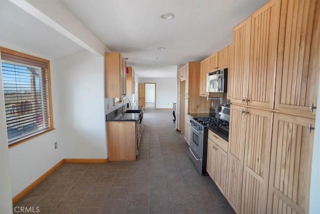 kitchen with light brown cabinets, sink, and stainless steel appliances