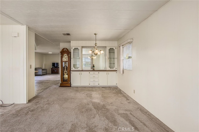 unfurnished dining area with light carpet