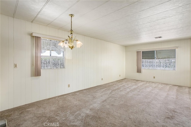 spare room with wooden walls and carpet