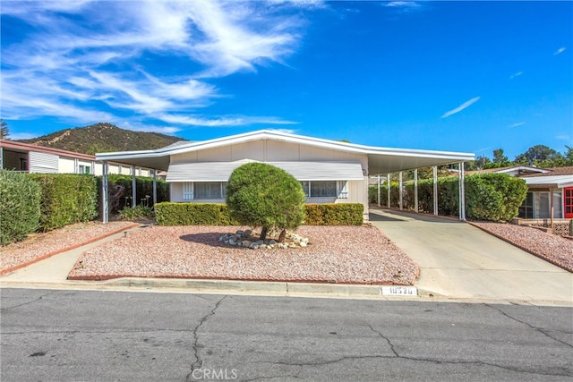 view of front of home with a mountain view and a carport