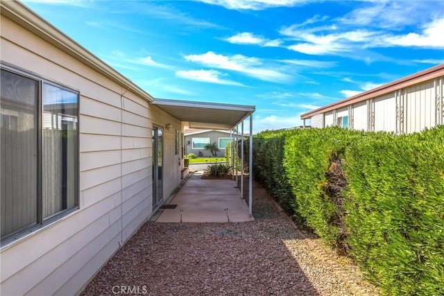 view of side of property featuring a patio