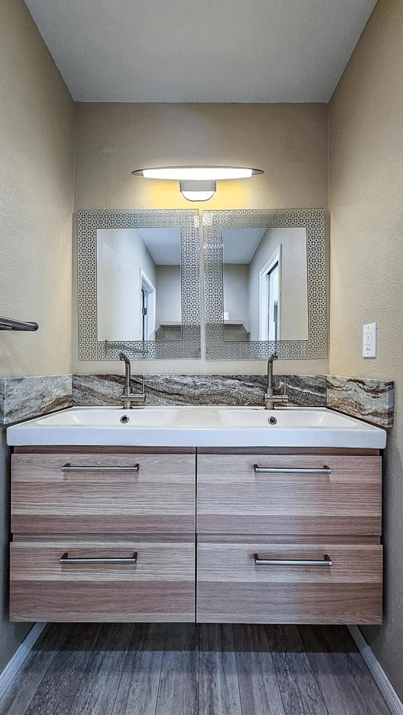 bathroom with vanity and hardwood / wood-style floors