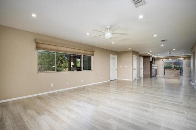 unfurnished living room with light wood-type flooring and ceiling fan