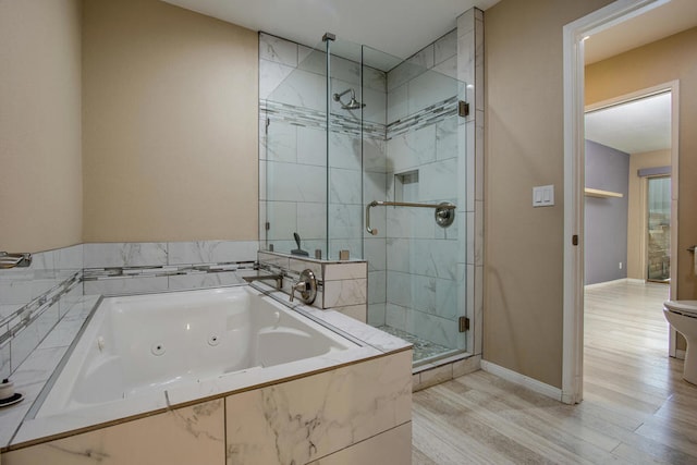 bathroom with wood-type flooring, independent shower and bath, and toilet