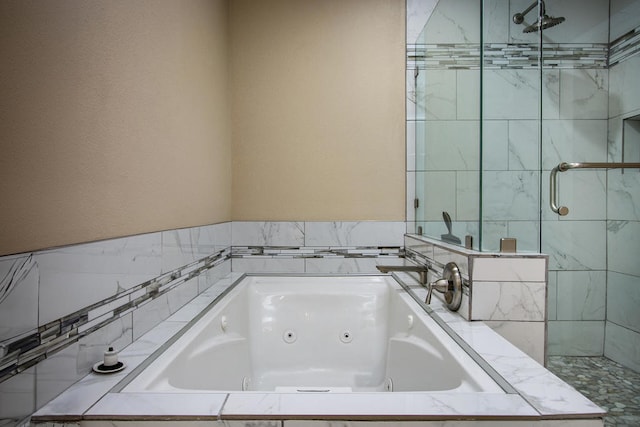 bathroom featuring separate shower and tub