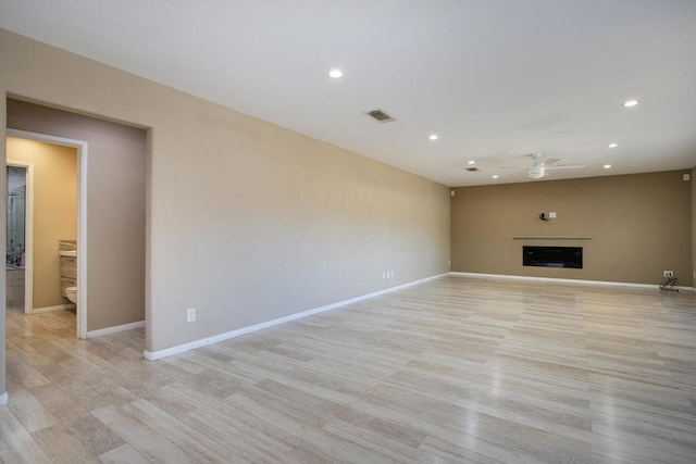 unfurnished living room featuring light hardwood / wood-style flooring and ceiling fan