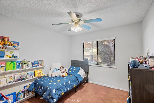 carpeted bedroom featuring a textured ceiling and ceiling fan