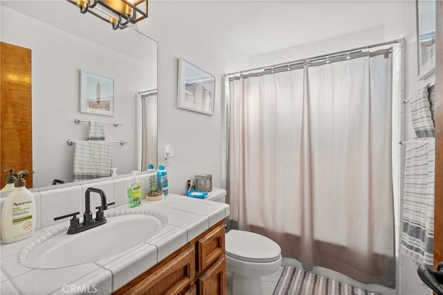 full bathroom with vanity, tile patterned flooring, toilet, shower / tub combo, and a chandelier