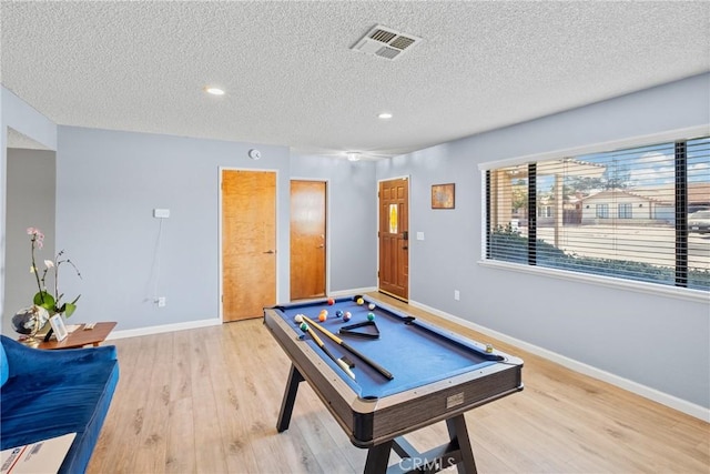 recreation room featuring light hardwood / wood-style floors, a textured ceiling, and billiards