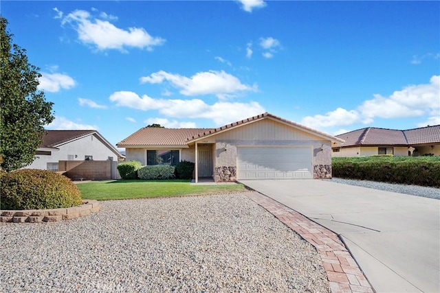 ranch-style house featuring a garage and a front lawn