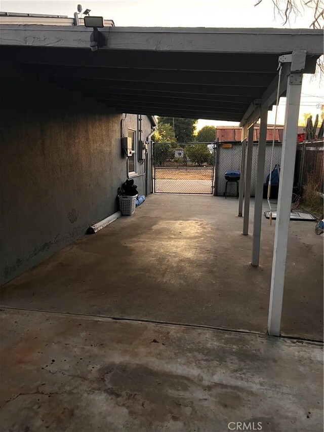 view of parking / parking lot featuring a carport