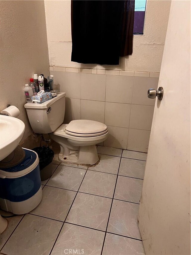 bathroom with tile patterned floors and toilet