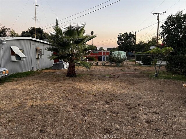 yard at dusk with cooling unit