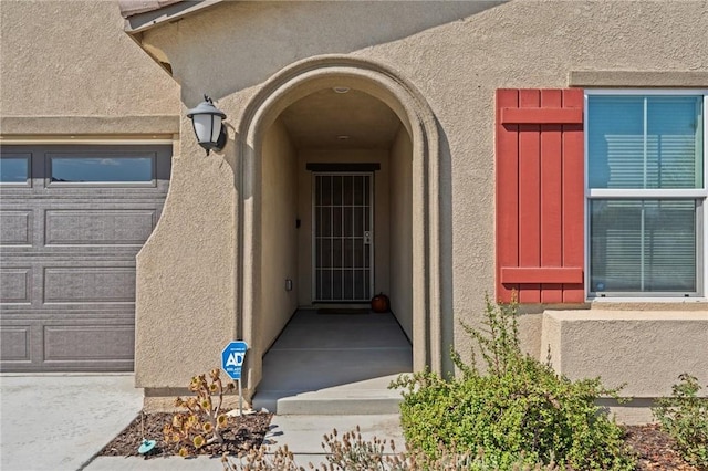 view of exterior entry featuring a garage