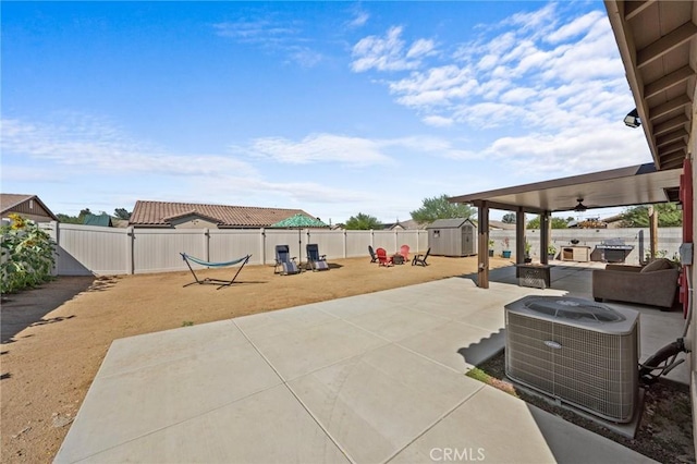 view of patio featuring ceiling fan, cooling unit, and a storage shed