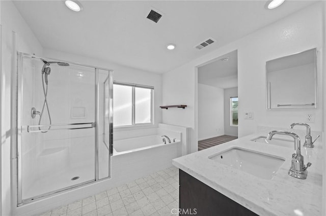 bathroom featuring vanity and separate shower and tub