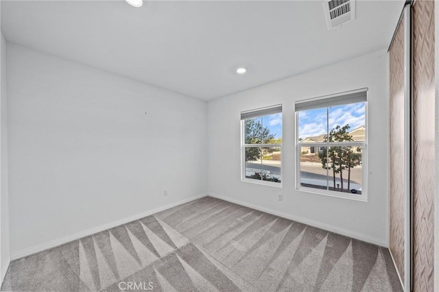 unfurnished room with light colored carpet