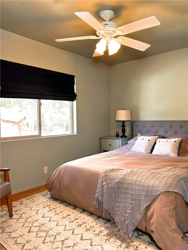 bedroom with ceiling fan and light hardwood / wood-style flooring