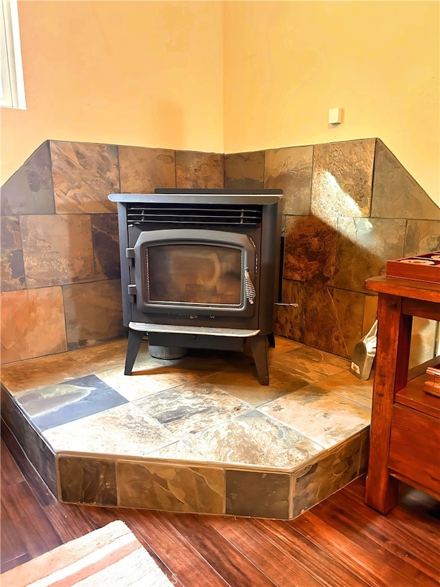 room details featuring wood-type flooring and a wood stove