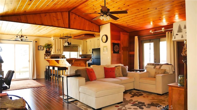 living room featuring vaulted ceiling, ceiling fan with notable chandelier, wooden ceiling, and light wood-type flooring