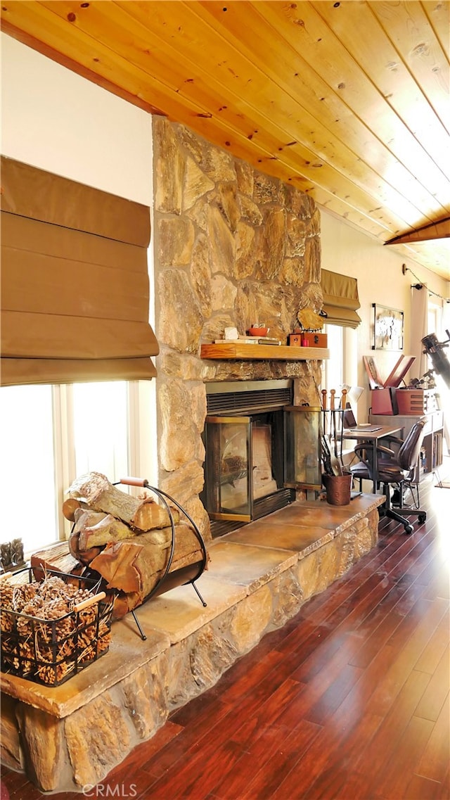 living room featuring a fireplace, wooden ceiling, a healthy amount of sunlight, and vaulted ceiling