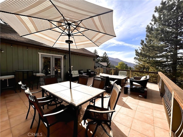 view of patio featuring french doors and a mountain view