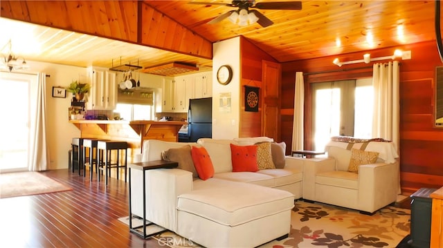 living room featuring plenty of natural light, wooden ceiling, and ceiling fan