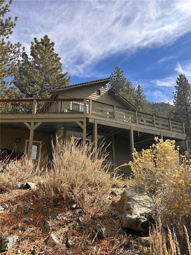 view of side of property featuring a wooden deck